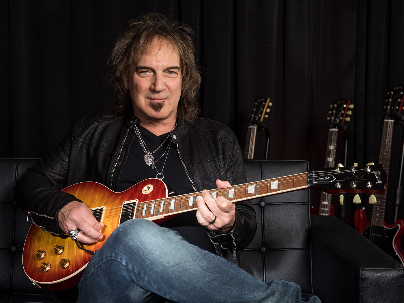 Gibson Dave Amato Les Paul Axcess Standard sat on couch