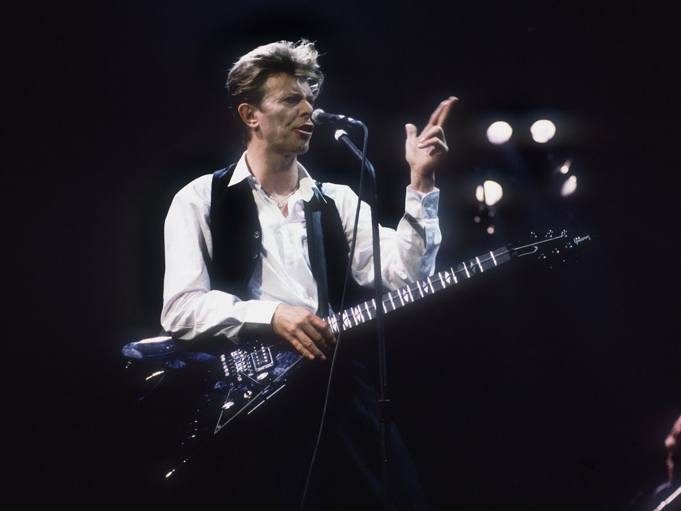 David Bowie on stage with flying v guitar