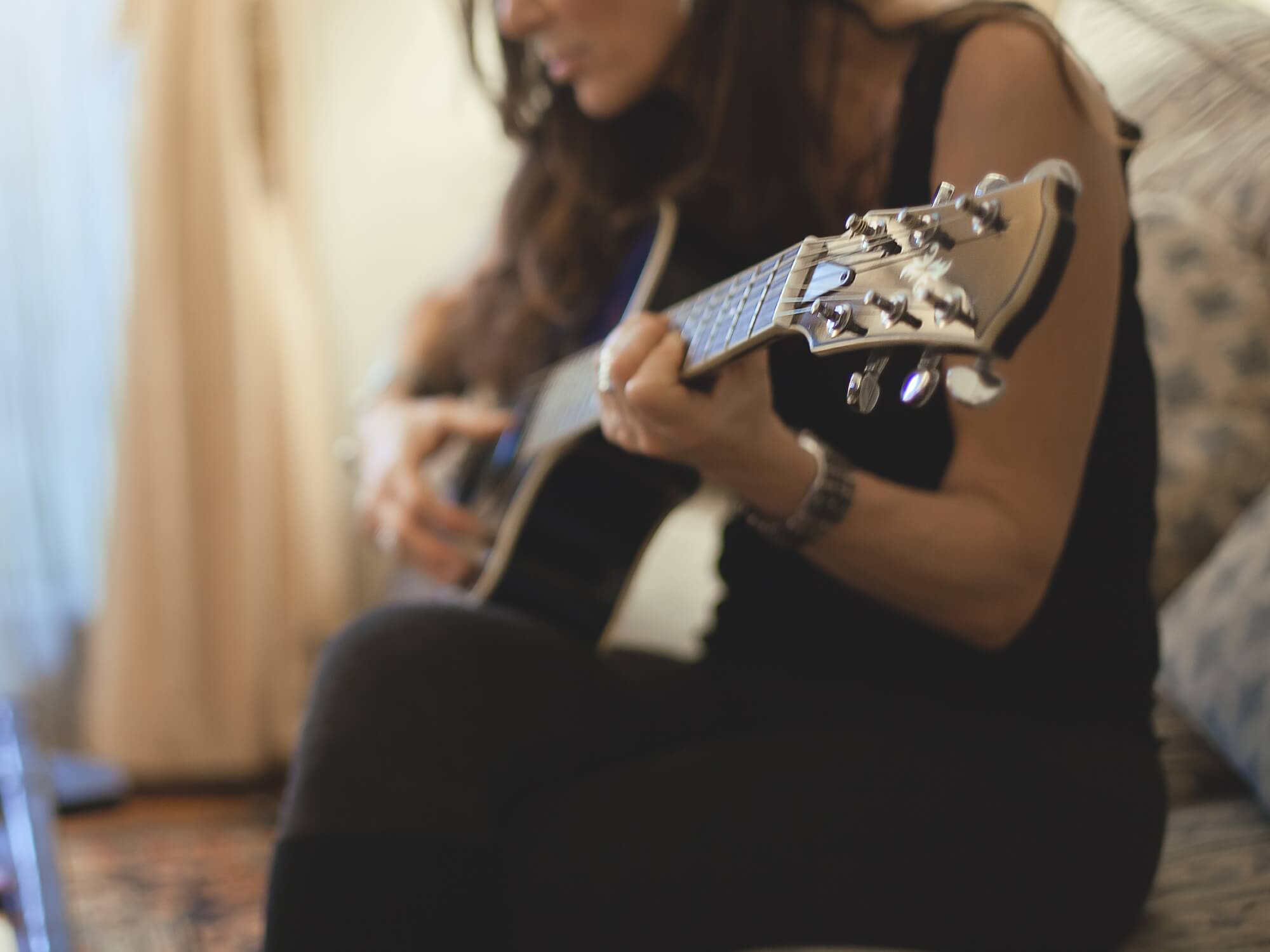 Woman playing a guitar