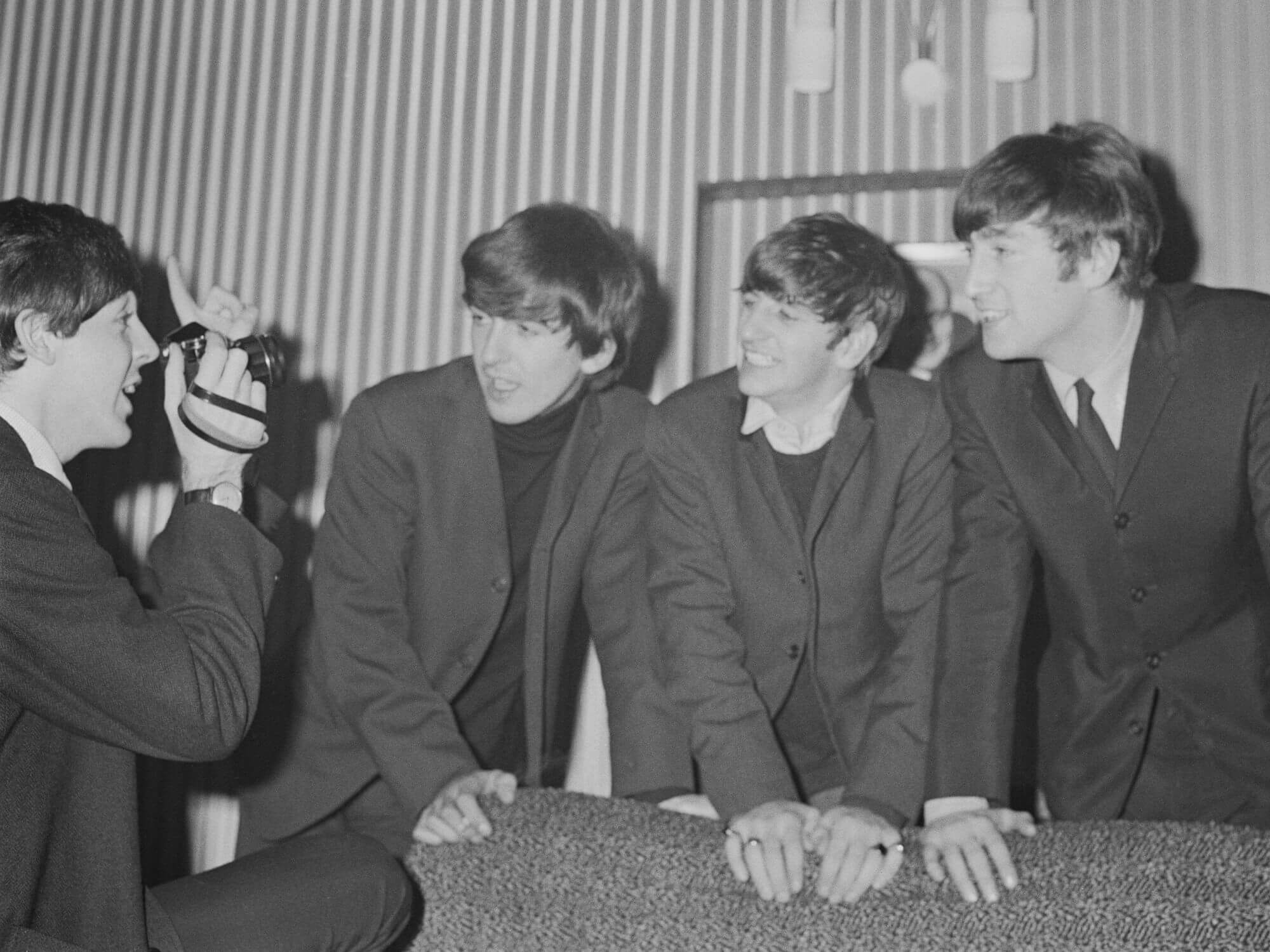 Paul McCartney photographing Beatles members in 1964