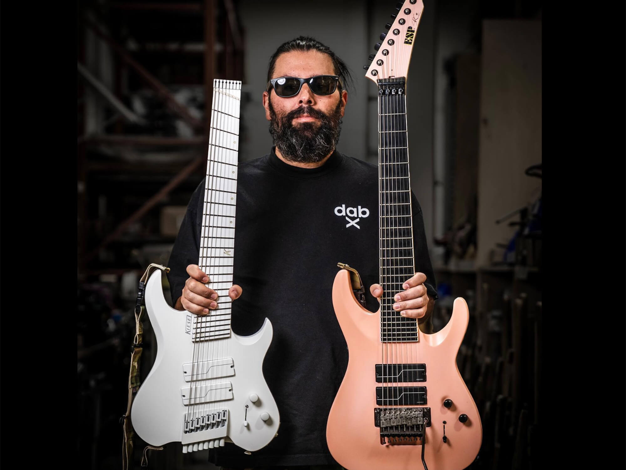 Stephen Carpenter holding two models - one from ESP, one from Kiesel