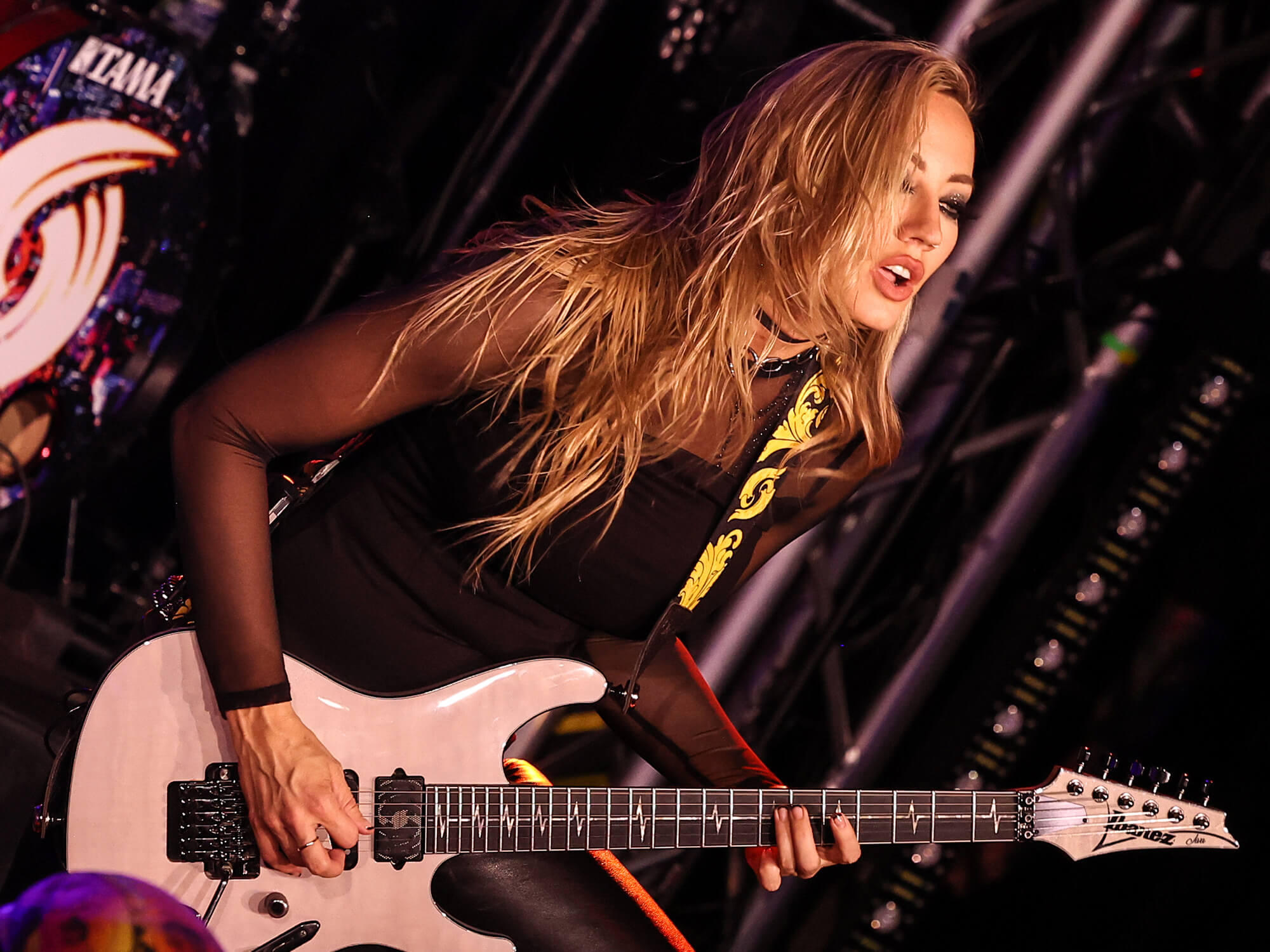 Nita Strauss playing guitar onstage