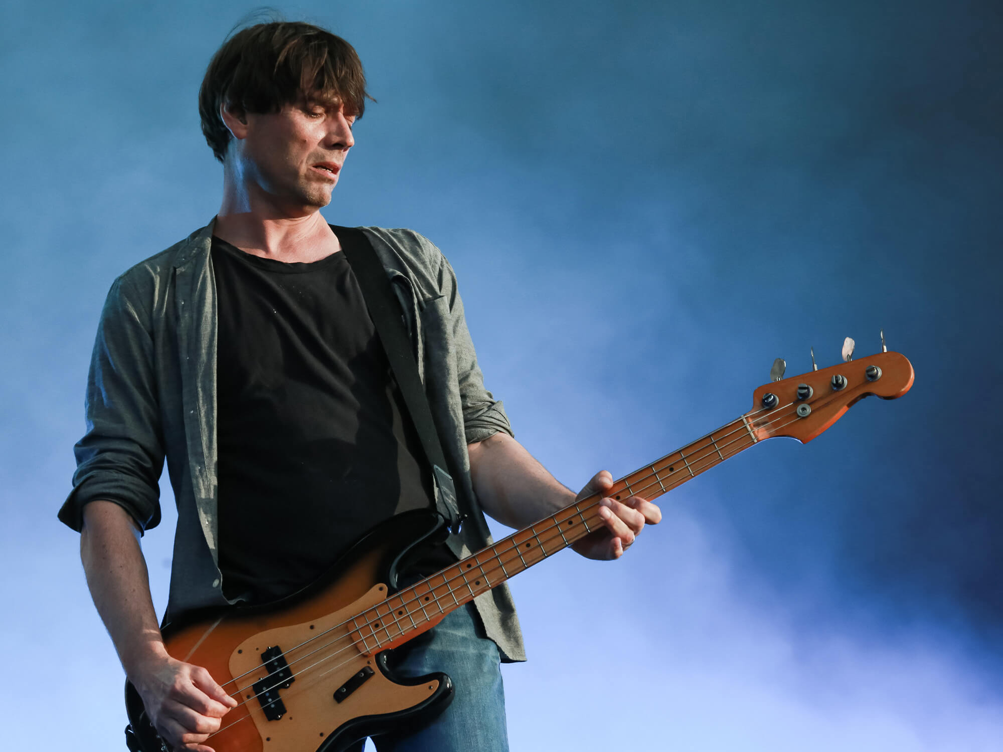 Alex James with his bass on stage in 2015