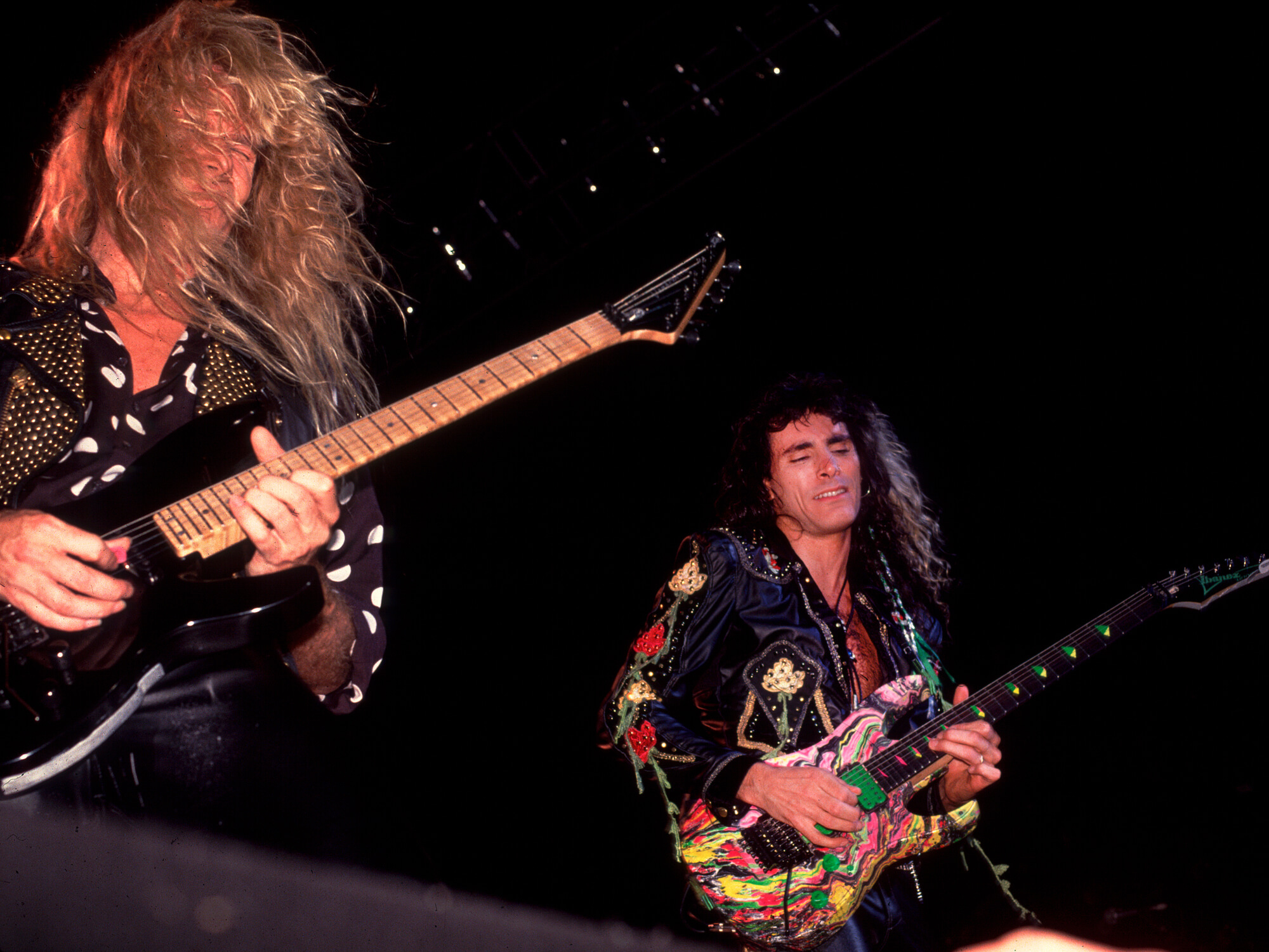Adrian Vandenberg (left) and Steve Vai (right) performing as Whitesnake