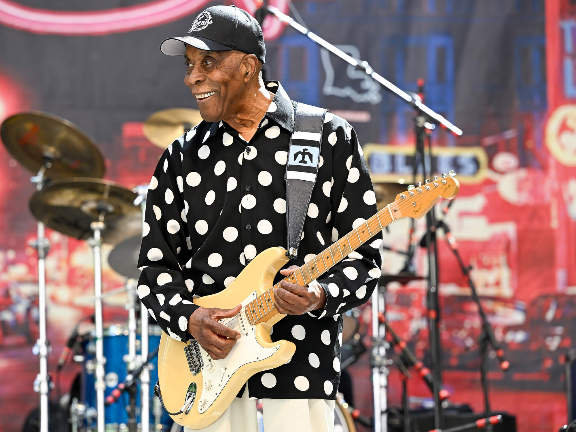 Buddy Guy wearing a black and white polka dot shirt, playing a blonde Stratocaster