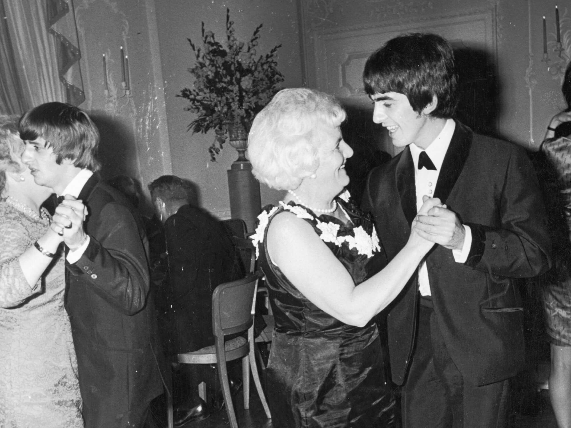 Black and white photo of George Harrison dancing with his mother Louise