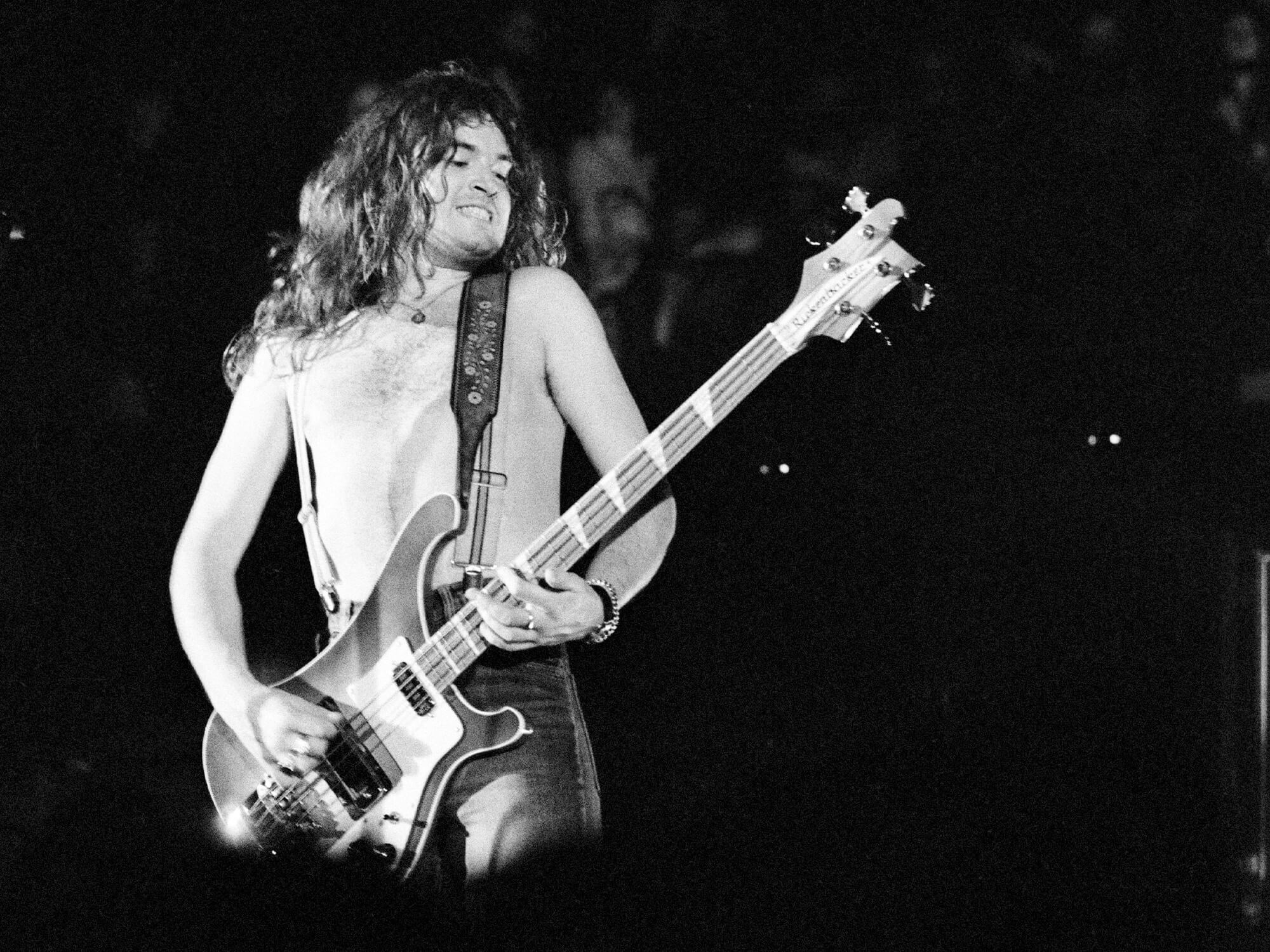 Black and white photos of Glenn Hughes performing in the mid 70s