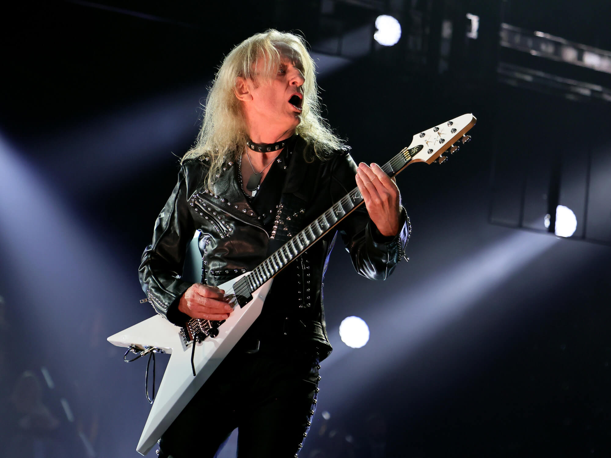 KK Downing playing the guitar on stage