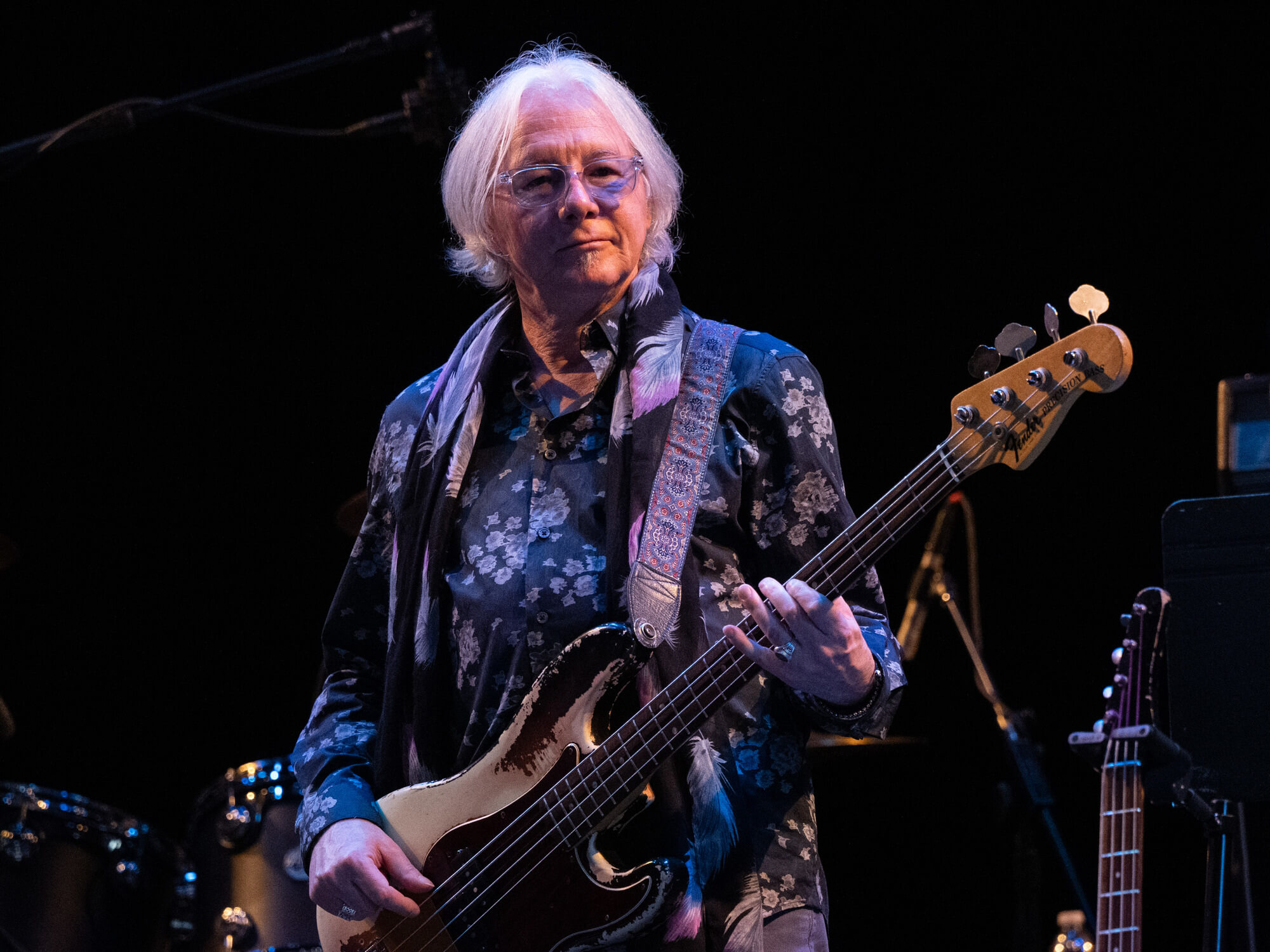 Mike Mills of R.E.M. performing on stage