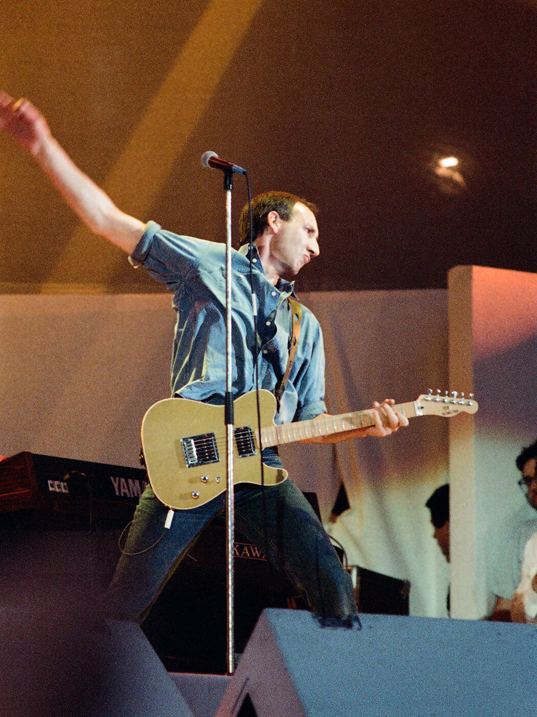 Pete Townshend of The Who performing with a gold Schecter guitar at Live Aid in 1985 by Pete Still/Redferns via Getty Images