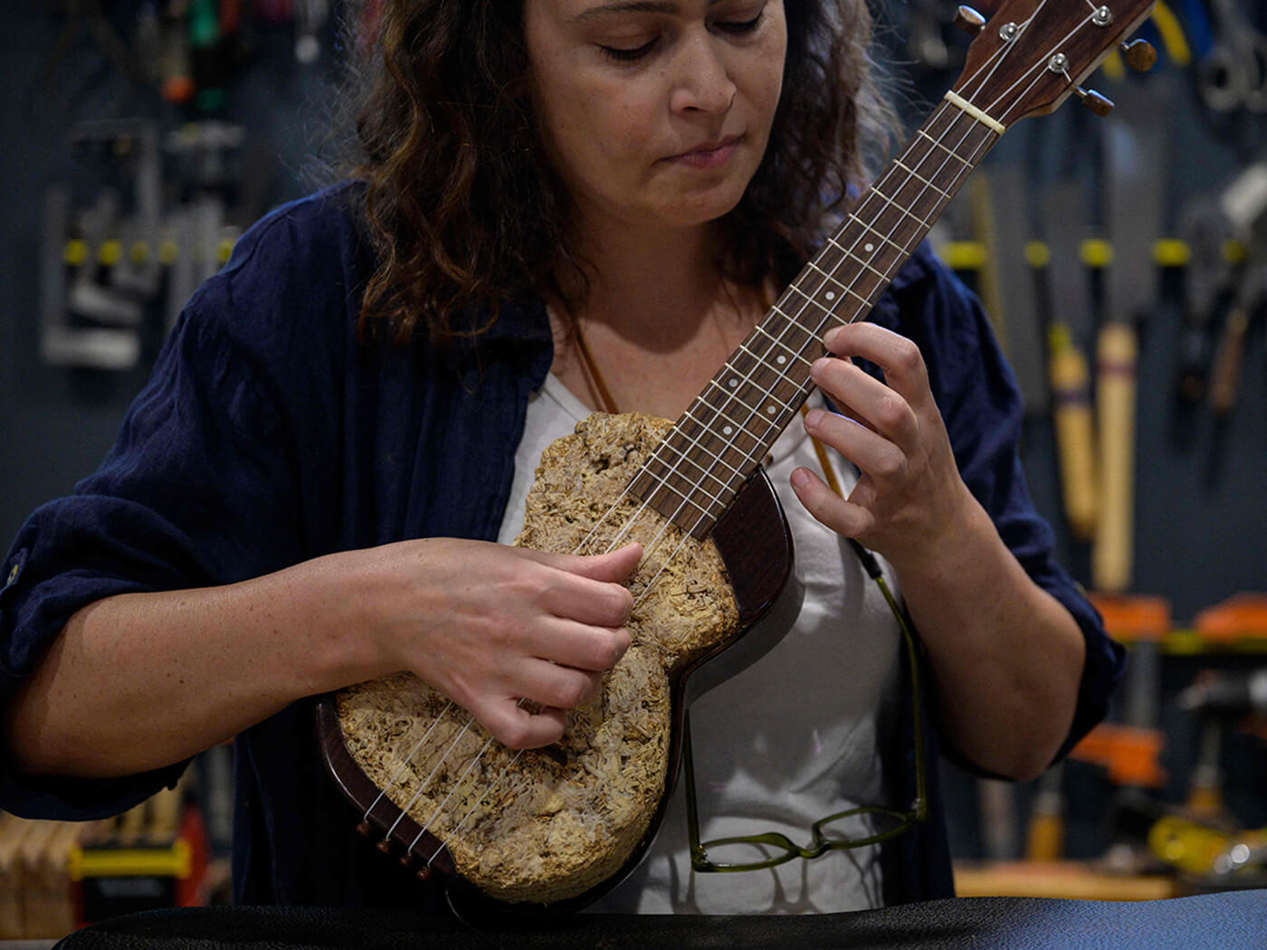 Rachel Rosenkrantz playing a ukelele made using mycelium
