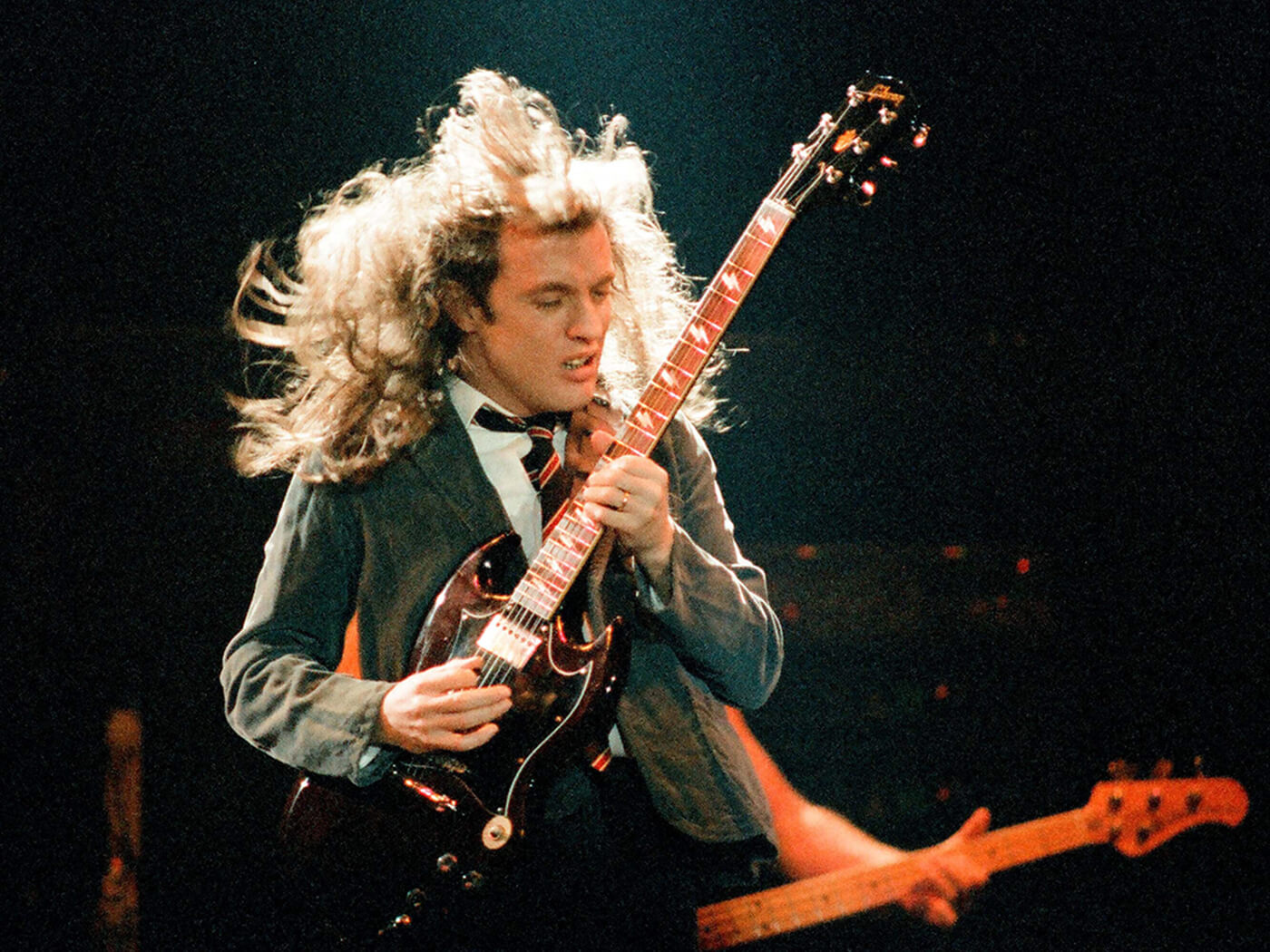 Angus Young of AC/DC performing in 1986 with a Gibson SG by Pete Still/Redferns via Getty Images