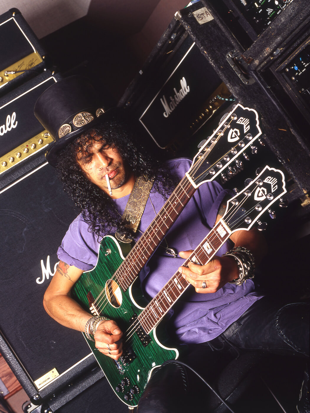 Slash playing a double-necked Guild guitar by Robert Knight Archive/Redferns via Getty Images