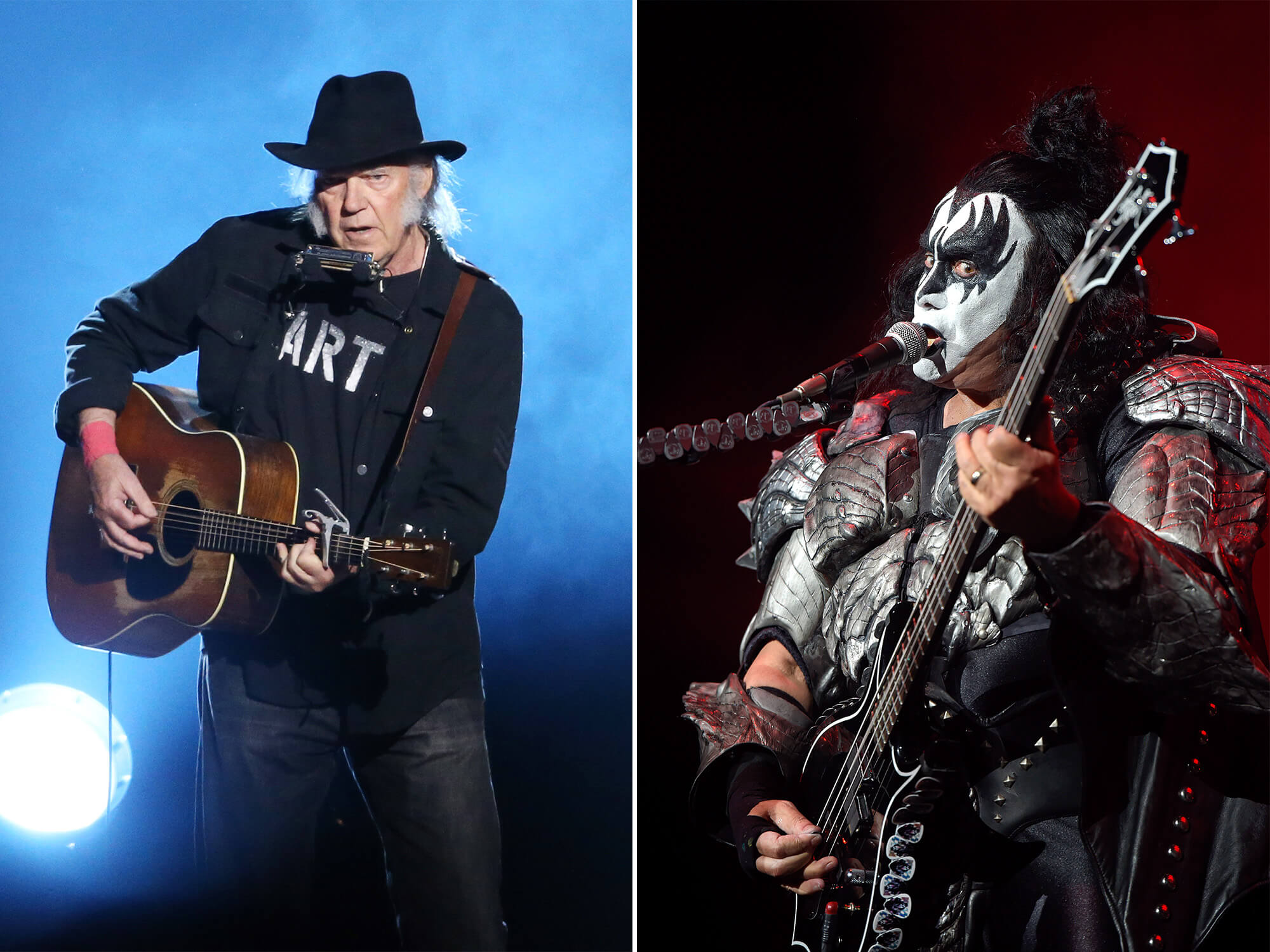 Neil Young (left) playing an acoustic guitar on stage. He is wearing a black hat and black clothes. Gene Simmons (right) with his black and white stage make up on. He is playing bass and singing into a mic.
