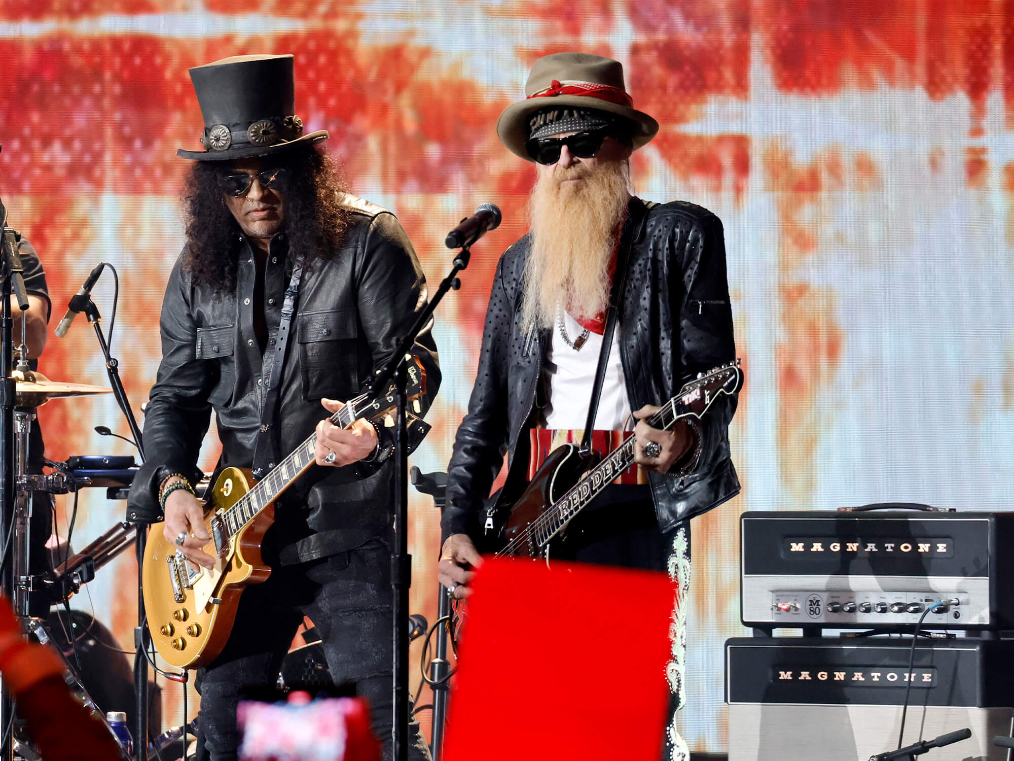 Slash and Billy Gibbons on stage. A Magnatone amp can be seen in the background.