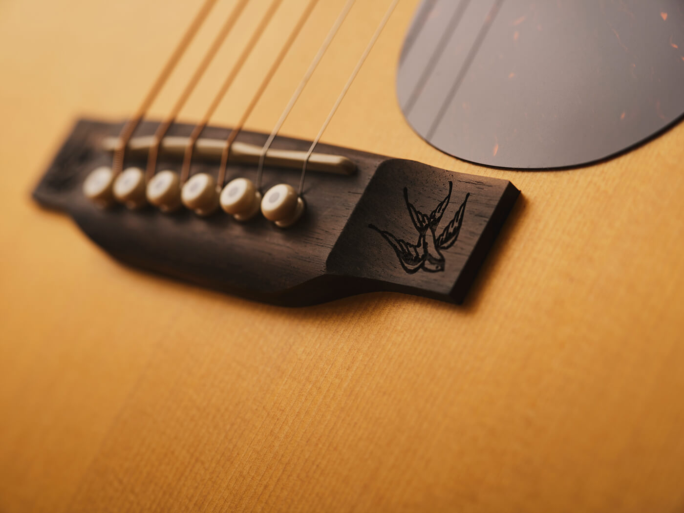 Laser-etched swallows on Shawn Mendes’ signature Martin Guitar, the 000JR-10E Shawn Mendes, photo by Adam Gasson