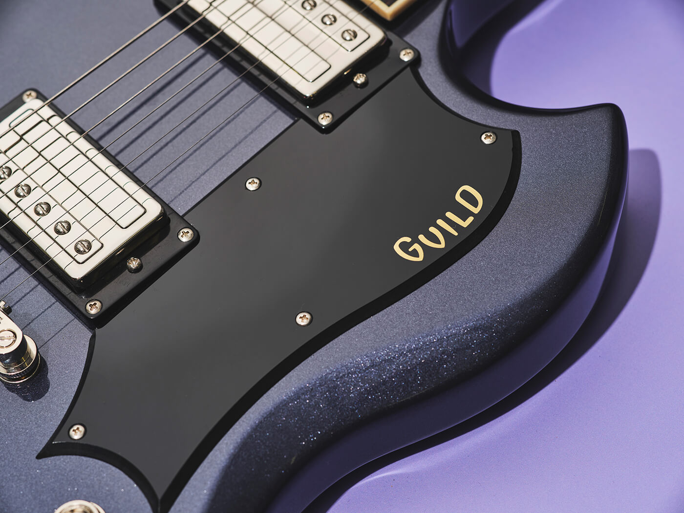 Pickguard with logo on the Guild Polara Deluxe in canyon dusk, photo by Adam Gasson