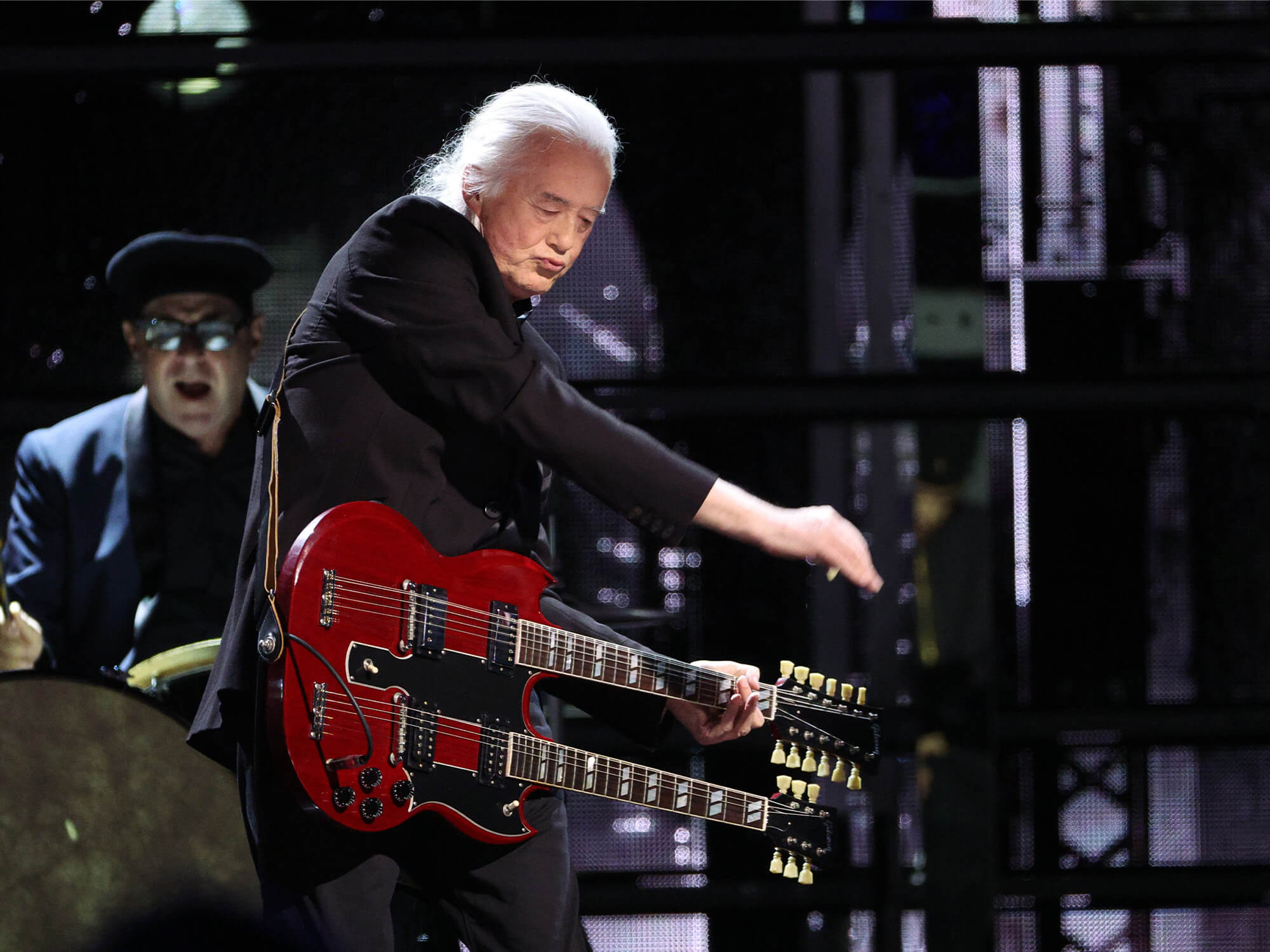 Jimmy Page playing the double neck guitar on stage