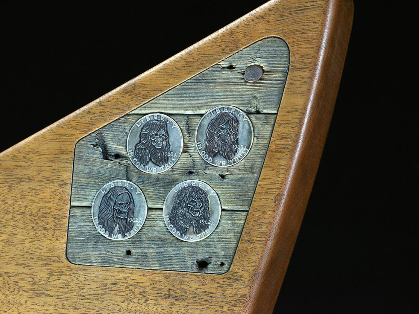 Ben Franklin silver half-dollar coins inlaid into a panel of the Garage wood, each engraved with skull characters of James, Lars, Kirk, and Cliff, and from each member’s birth year, photo by Ken Lawrence