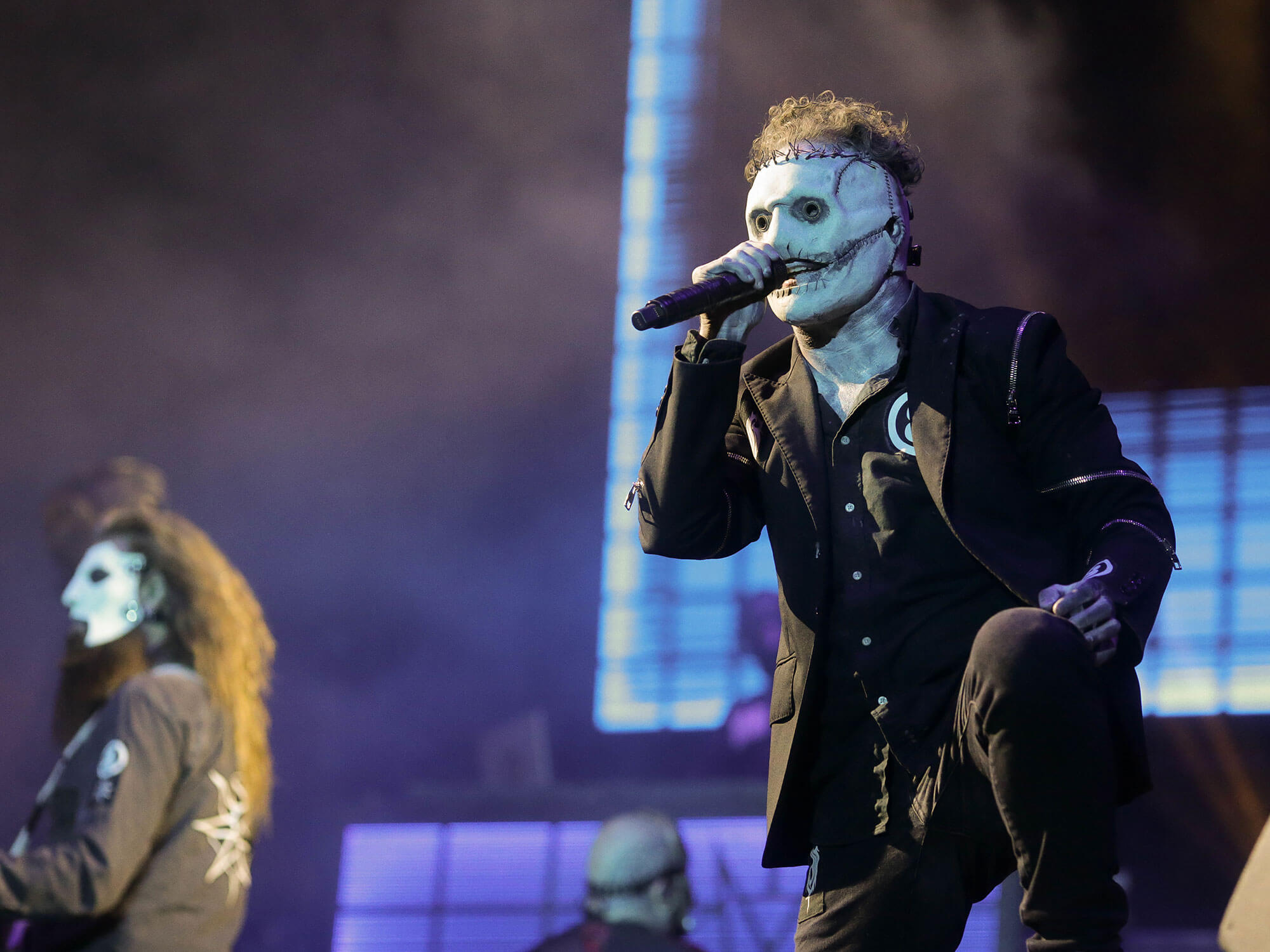 [L-R] Jim Root (in the background) and Corey Taylor of Slipknot performing live