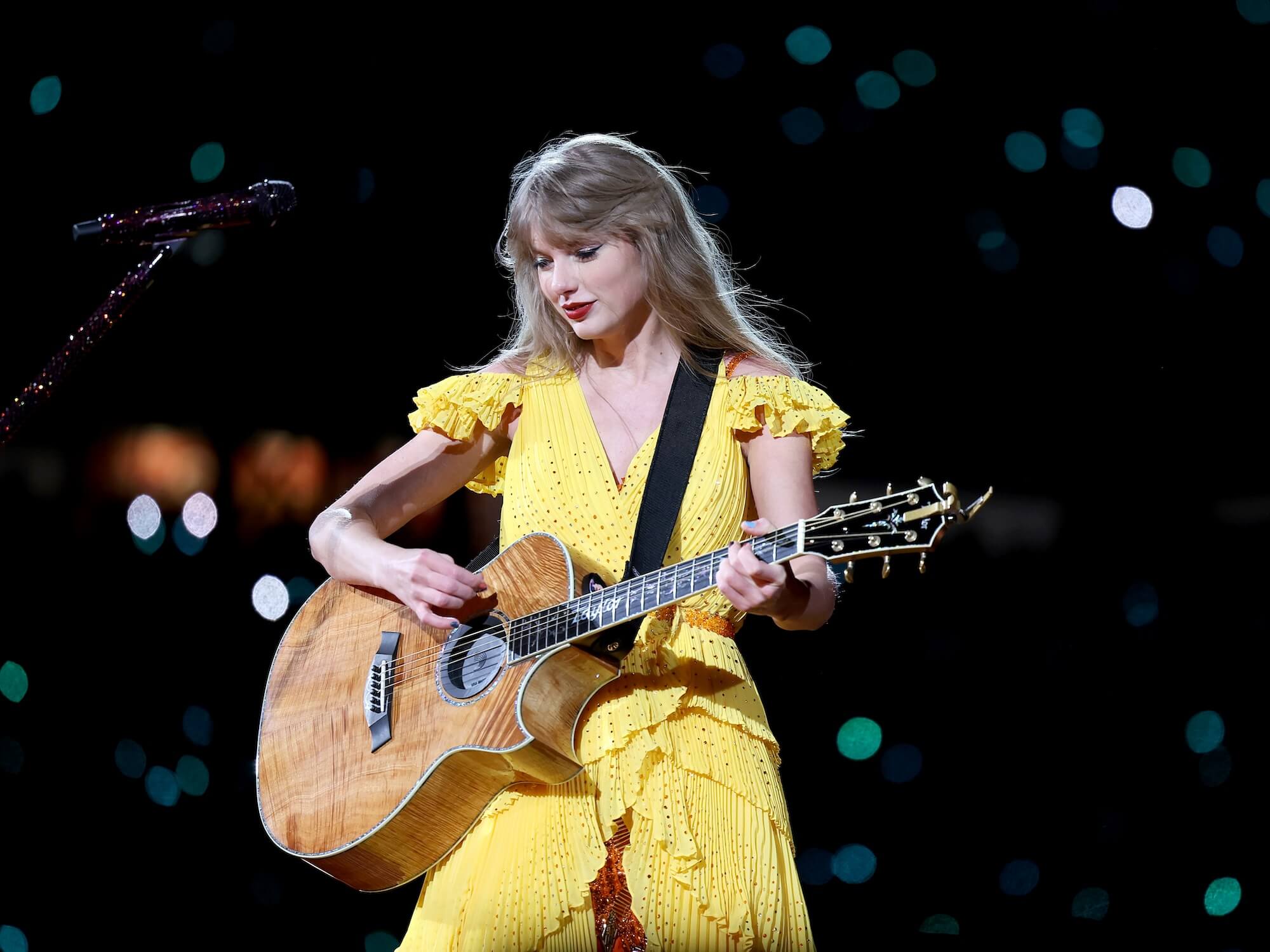 Taylor Swift performing with a Taylor PS24 at the Eras Tour in Massachusetts, 2013, photo by Scott Eisen/TAS23/Getty Images for TAS Rights Management