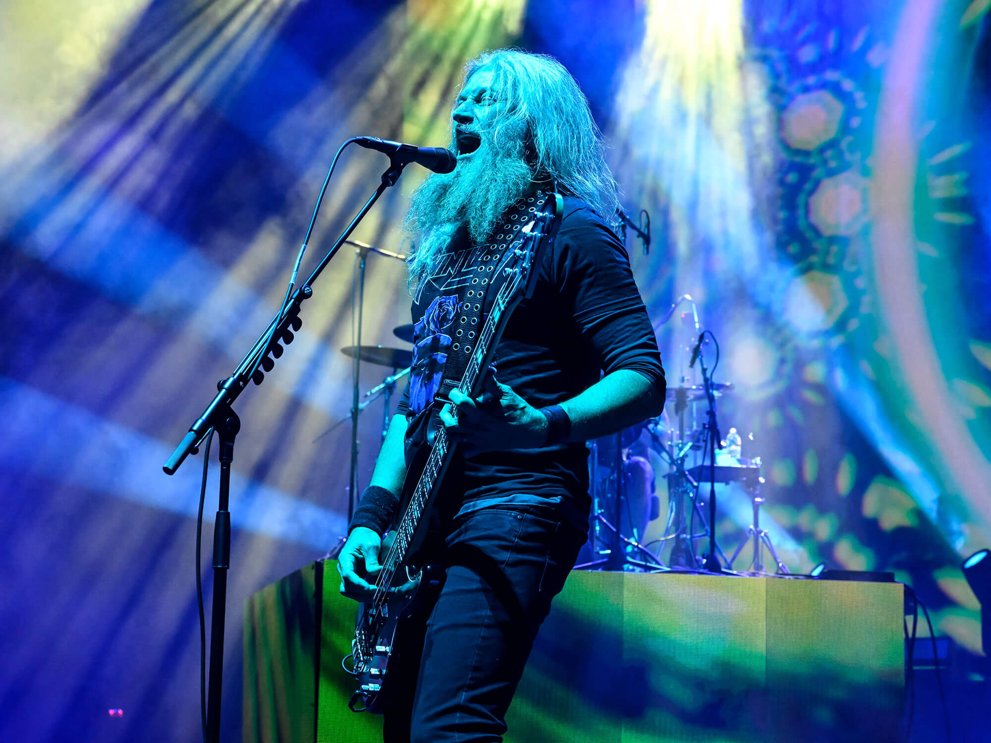 Troy Sanders performs onstage with Mastodon