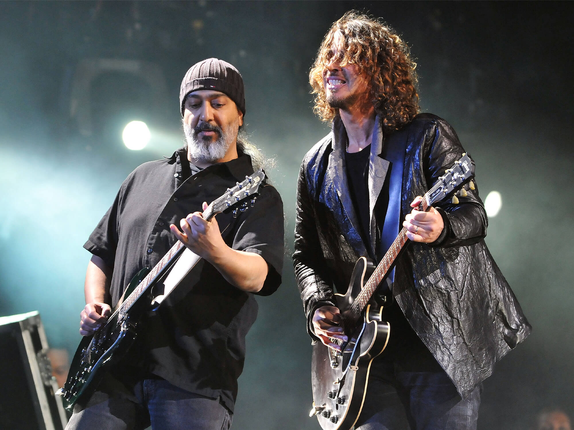 Kim Thayil and Chris Cornell playing guitar together on stage in 2012.