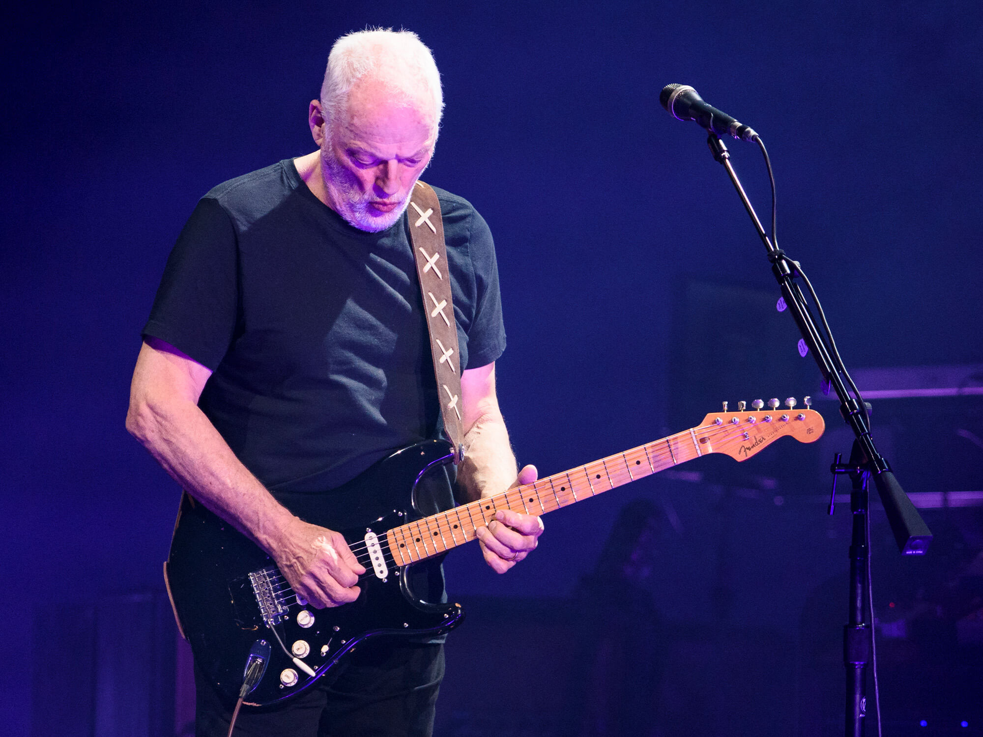 David Gilmour on stage playing guitar