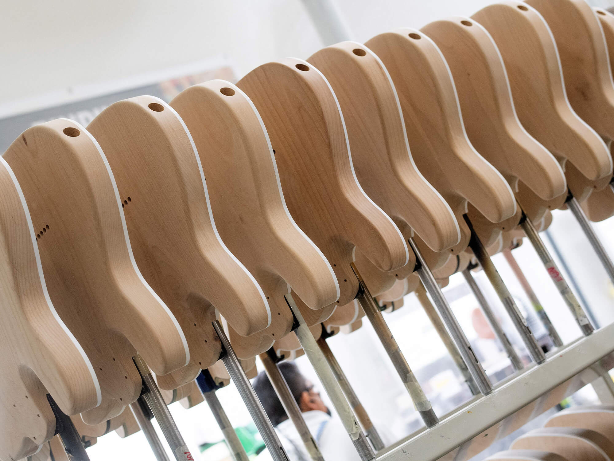 A line of wooden, unpainted Fender guitar bodies at its factory in California