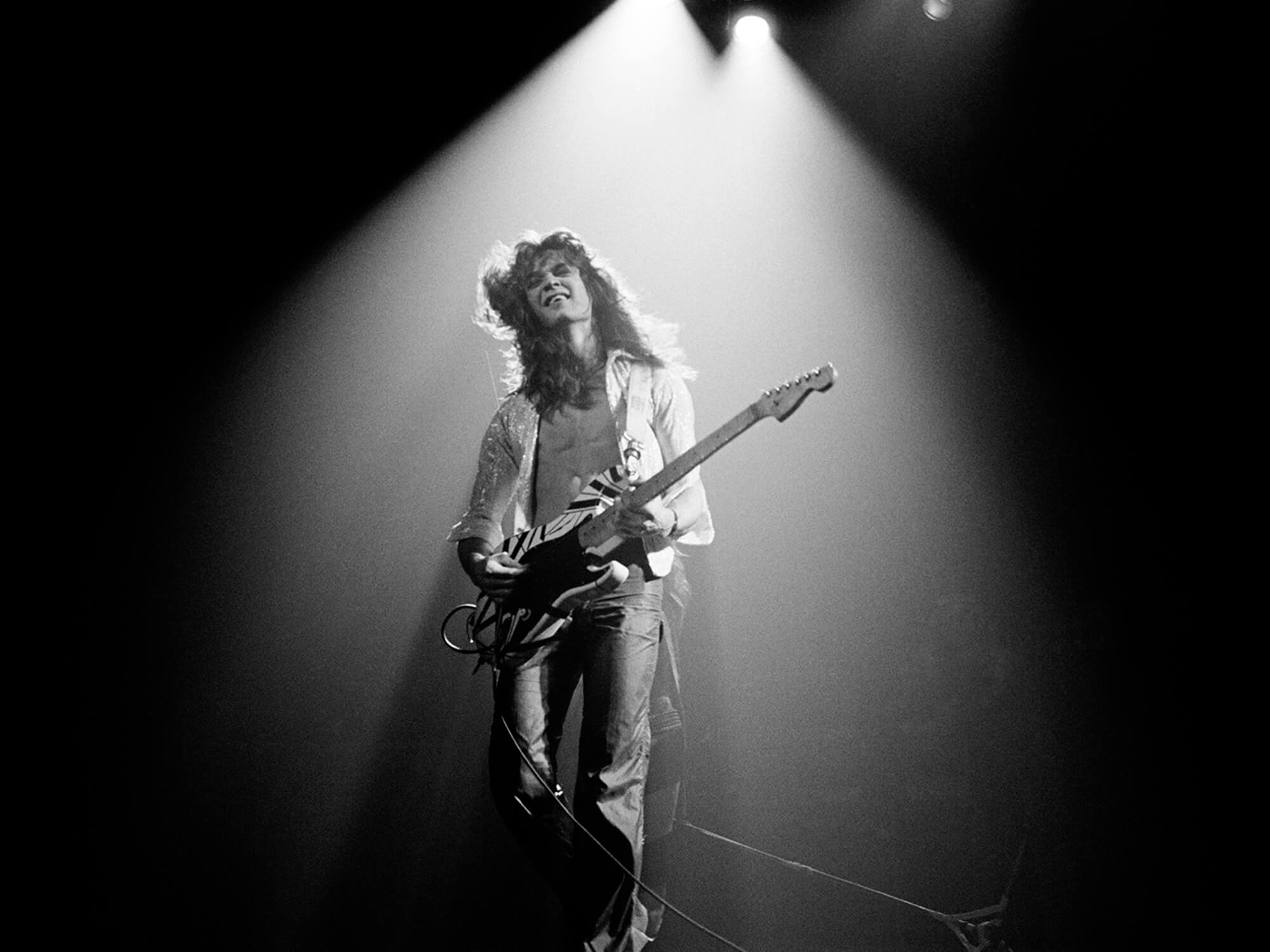 Eddie Van Halen performing in 1978, photo by Fin Costello/Redferns via Getty Images