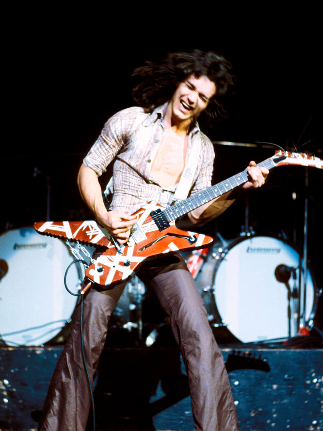 Eddie Van Halen performing onstage in 1978 with his Ibanez Destroyer, photo by Fin Costello/Redferns via Getty Images
