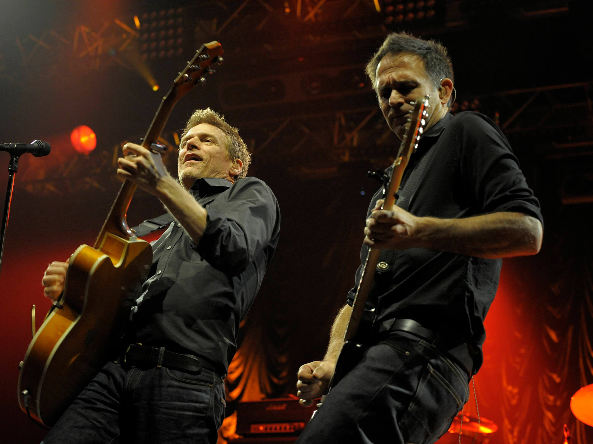Bryan Adams and Keith Scott pictured playing guitar together on stage