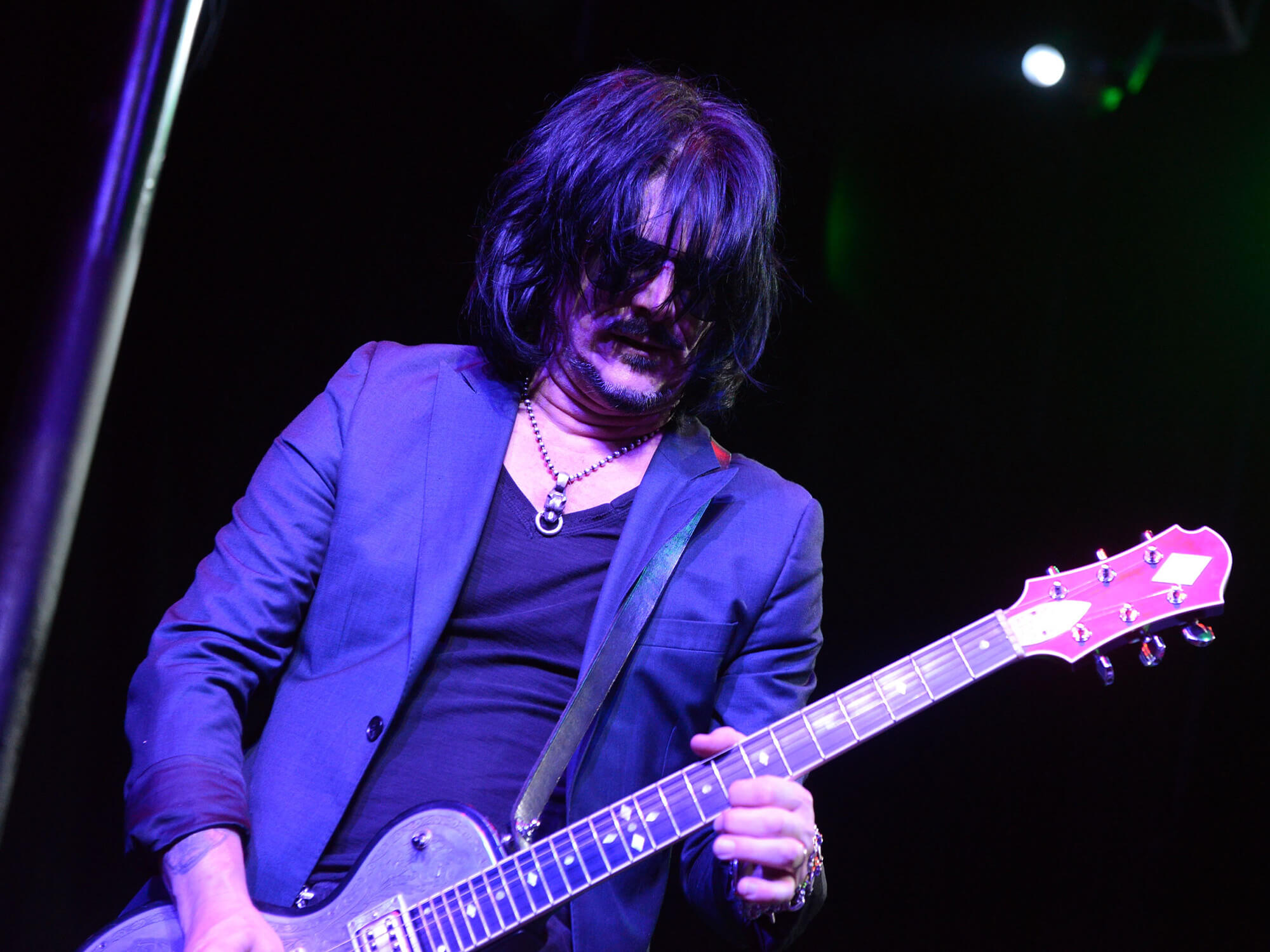 Gilby Clarke on stage playing guitar