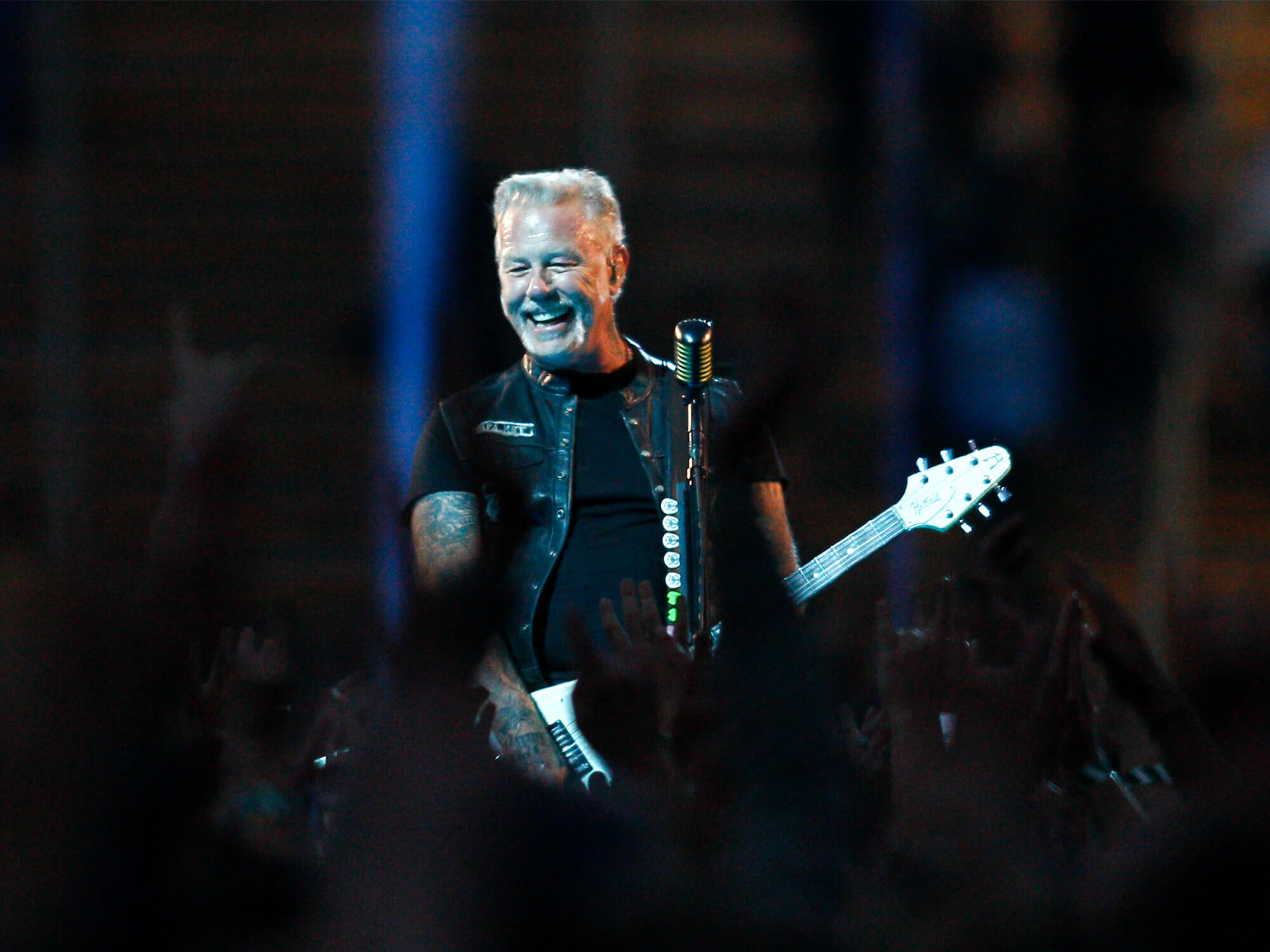 James Hetfield captured smiling at the crowd as he plays guitar in Munich on tour.