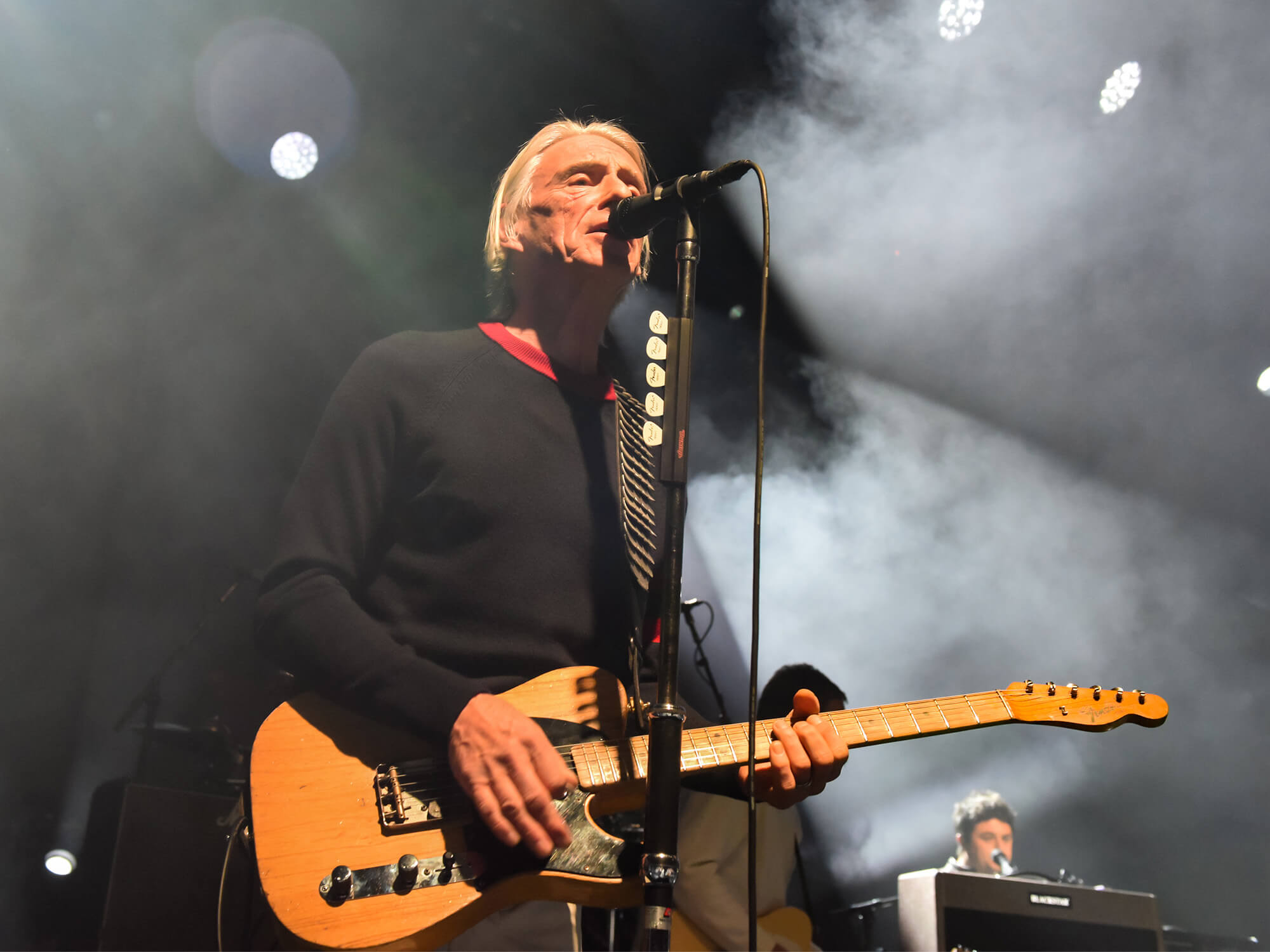Paul Weller on stage playing a Telecaster guitar