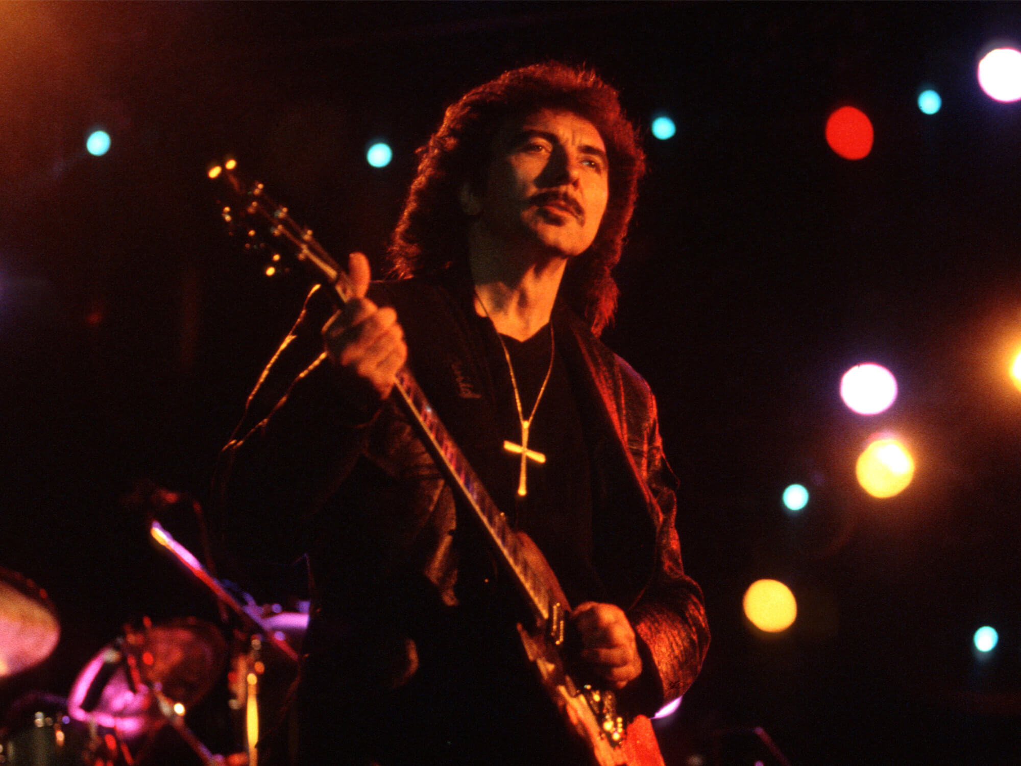 Tony Iommi pictured on stage with his guitar in the 90s
