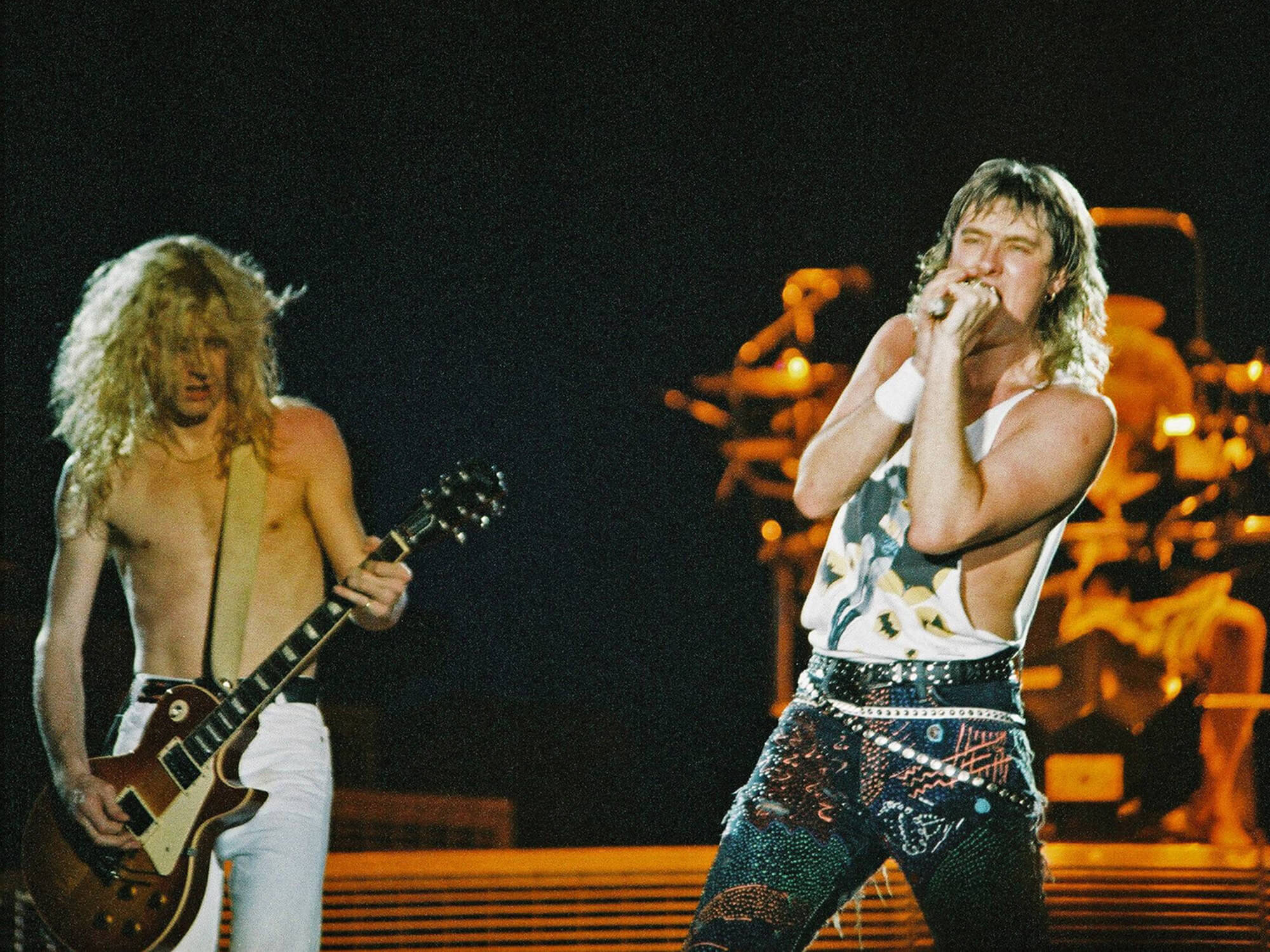Steve Clark and Joe Elliott of Def Leppard performing during the 1988 ‘Hysteria’ tour, photo by Pete Still/Redferns via Getty Images