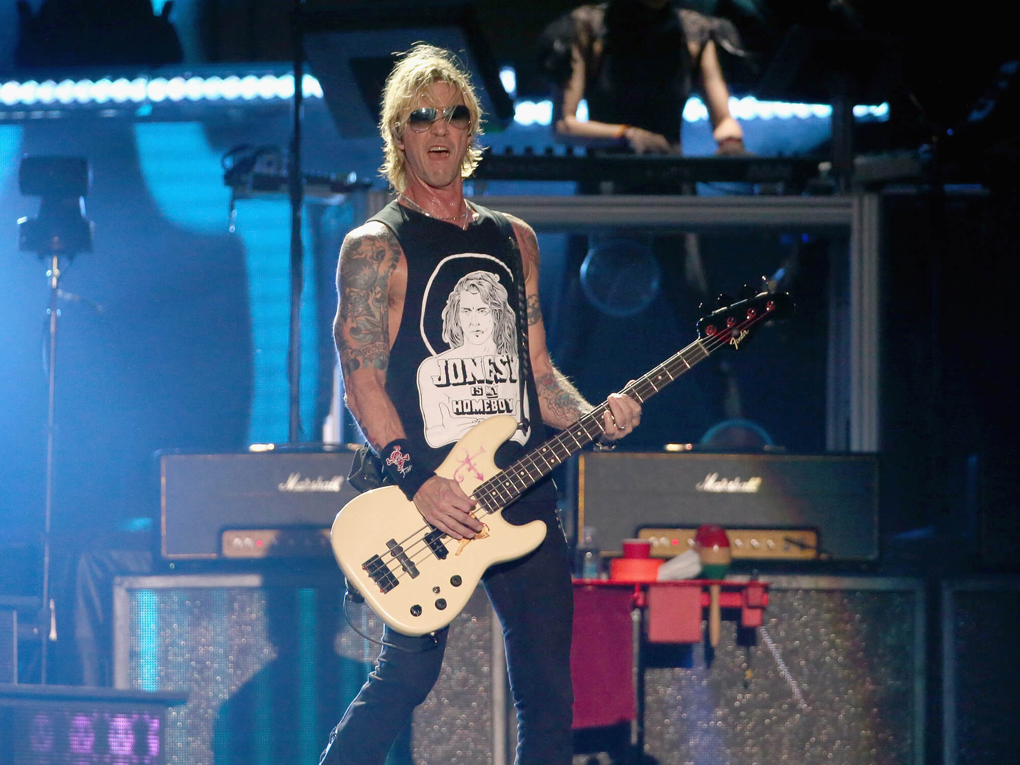 Duff McKagan playing bass on stage.