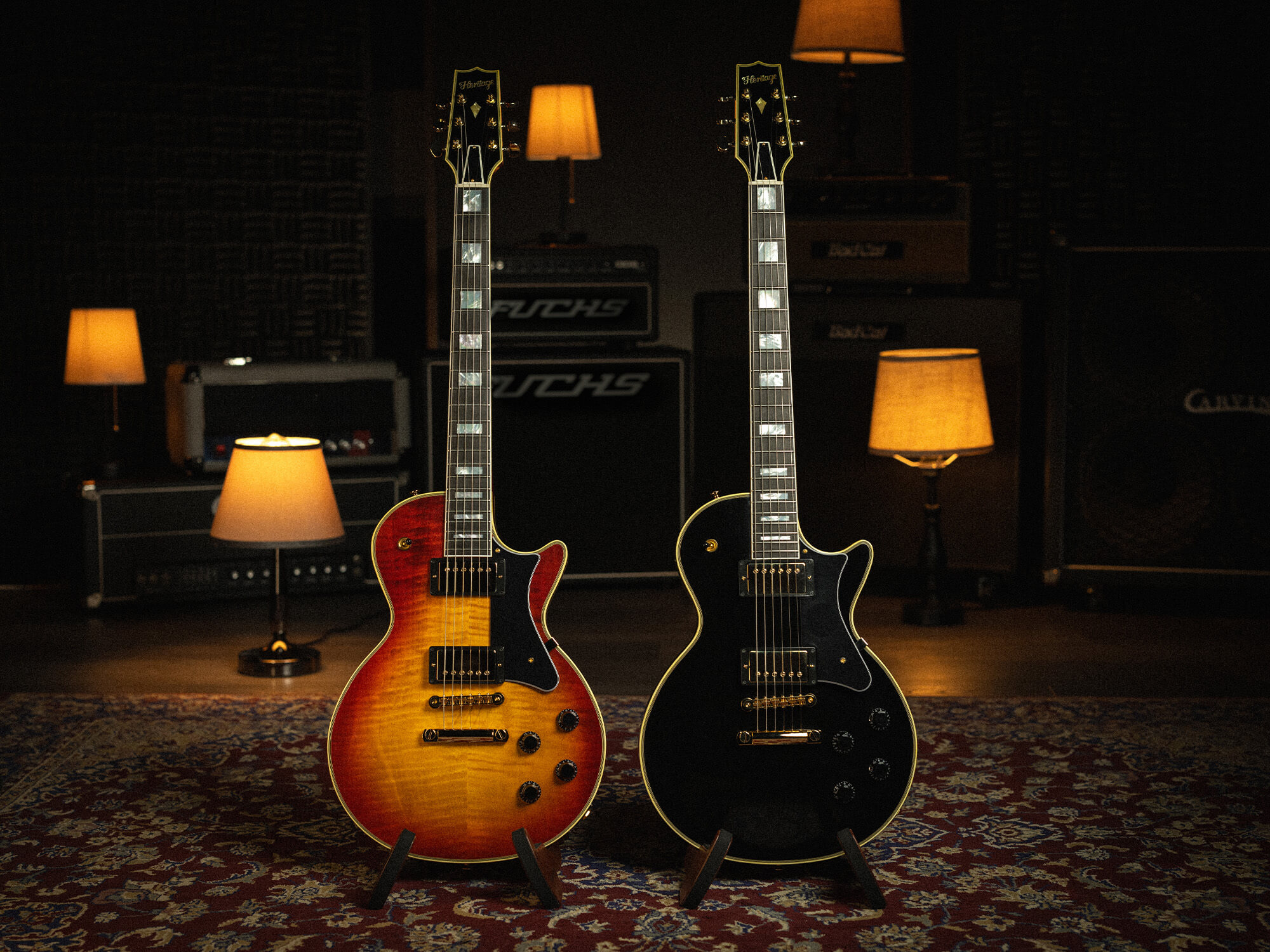Heritage H-157 models together. The 'burst (left) has a woody, orange into red colour on the body. The ebony (right) has a sleek black look.